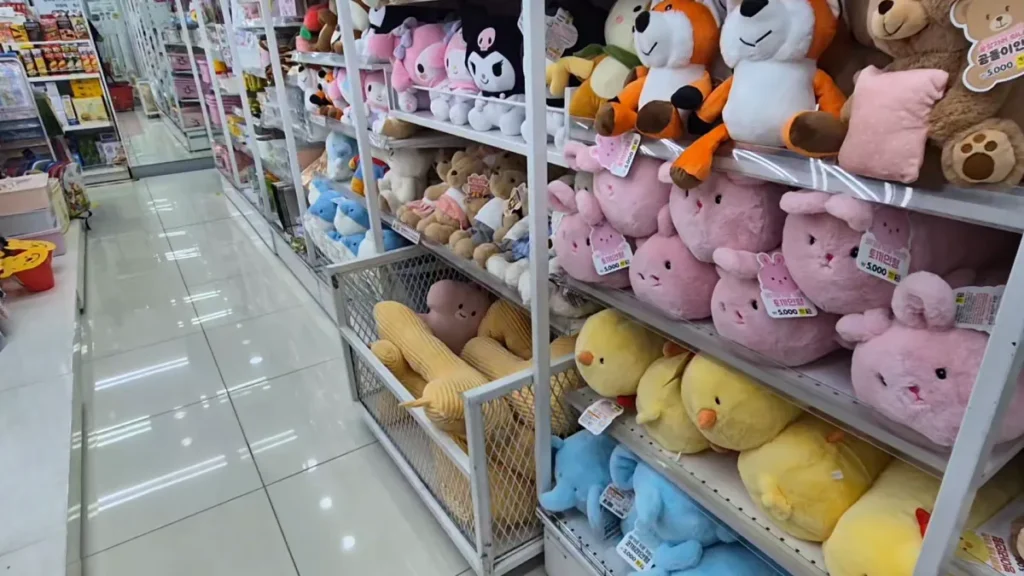 Cute plush toys displayed on shelves inside a Daiso store in Korea.