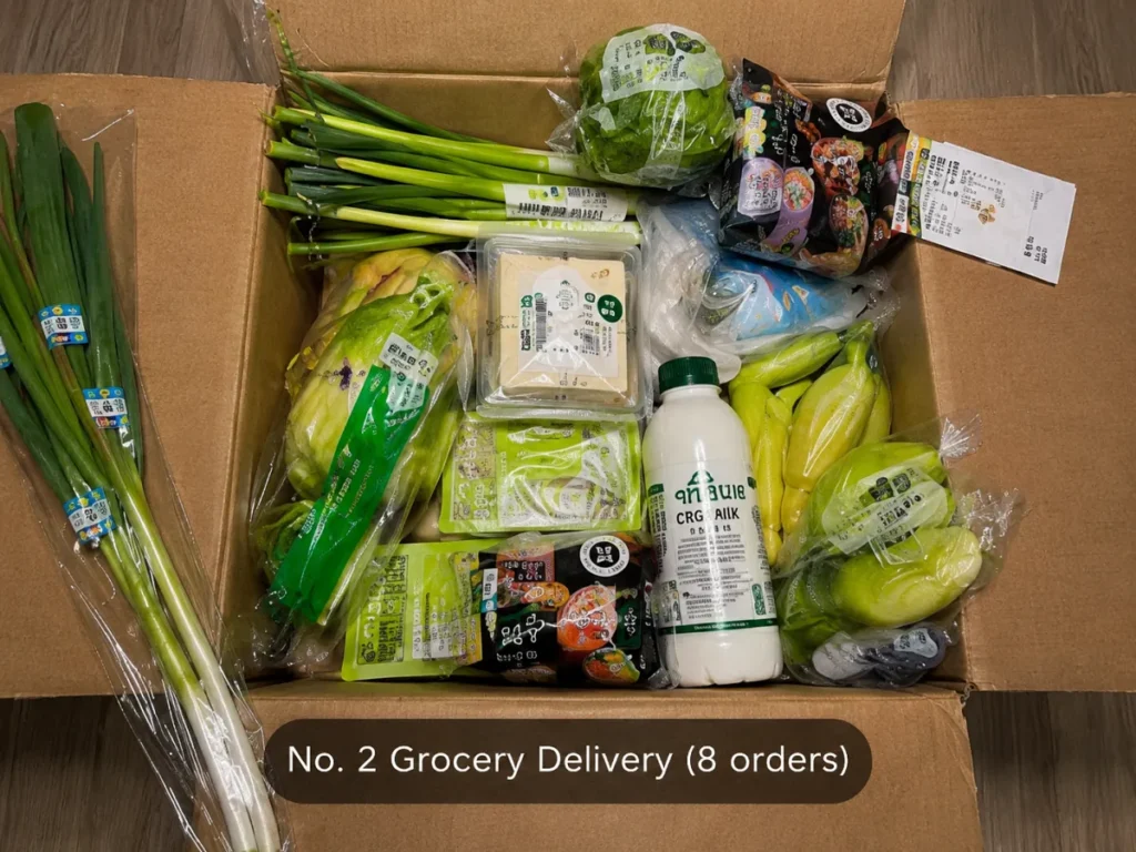 A grocery delivery box filled with fresh produce and household food items, ranked No. 2 with 8 orders.