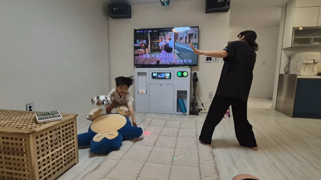 A private karaoke room inside a Korean pension with a family enjoying music and playtime.